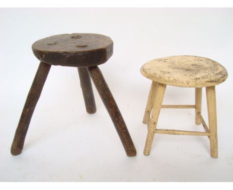 Rustic 18th/19th Century elm three legged milking stool, one leg carved A. H together with another similar painted cream (2).