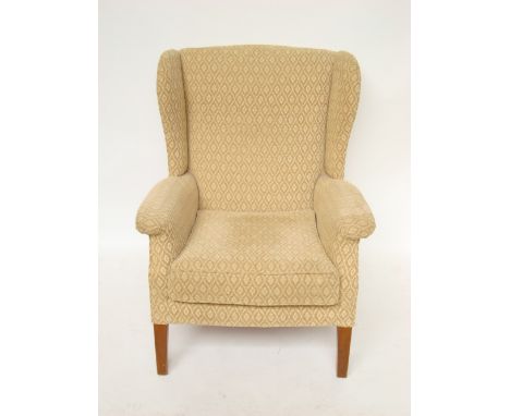 A parker Knoll upholstered wing armchair, model no 711. 