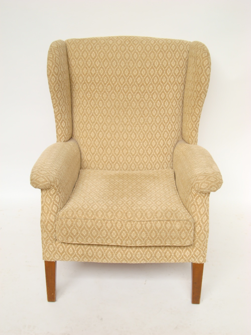 A parker Knoll upholstered wing armchair, model no 711.