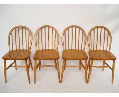 A set of four Ercol beech, ash and elm hoop stick back kitchen chairs, each bearing label 'Bowman Brothers Ltd, Complete Hous