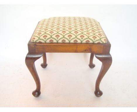 A walnut stool on cabriole legs with drop in seat.