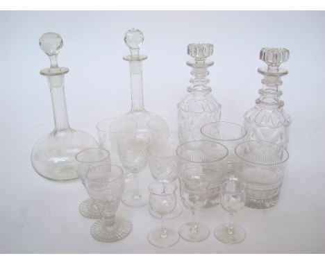 A pair of mid 19th Century cut glass spirit decanters and stoppers with triple ring necks, a pair of shaft and globe decanter