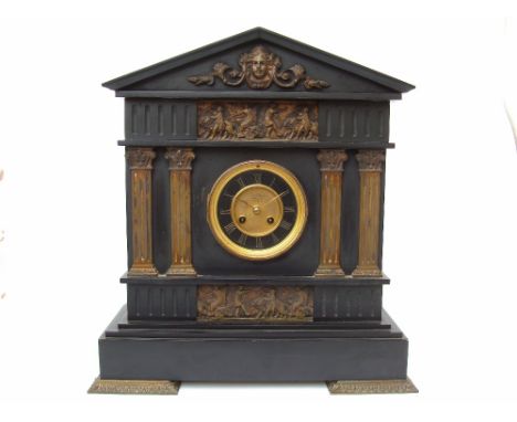 A late 19th Century architectural black slate gilt metal mounted mantel clock, the dial with Arabic numerals marked 'Exam'd b