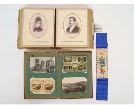 A late Victorian photograph album, of cabinet portrait photographs and an Edwardian album of postcards. 