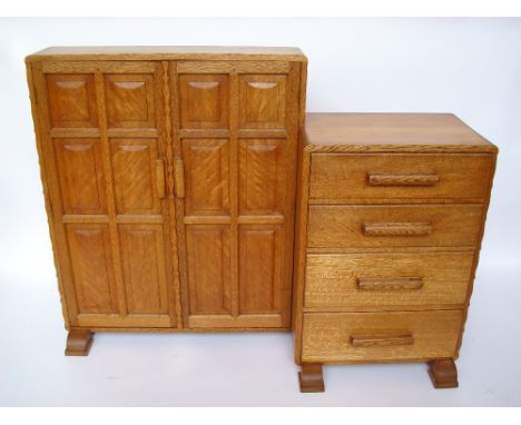 A mid 20th Century Cotswold school type light oak cupboard with attached lower section,  the cupboard with a pair of adzed fi