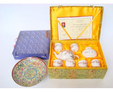 A Chinese porcelain tea service, comprising teapot, tea caddy and cover and six tea bowls, each piece decorated in colour ena