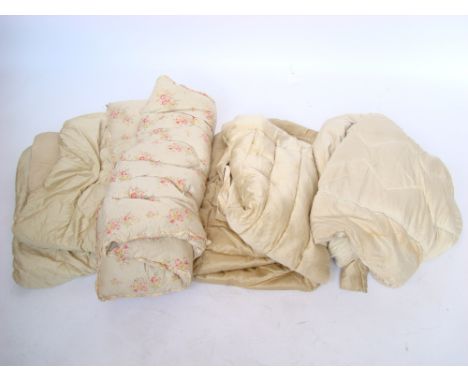 A vintage floral chintz feather eiderdown and four others, plain (5). 
