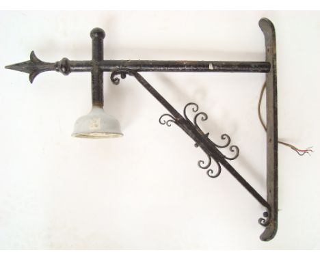 A 19th Century black painted cast iron wall bracket with ceramic pendant light fitting. 
