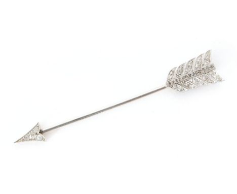 A 15ct diamond set jabot pin modelled as an arrow, pierced millegrain set platinum fletching and arrow head to a white on yel