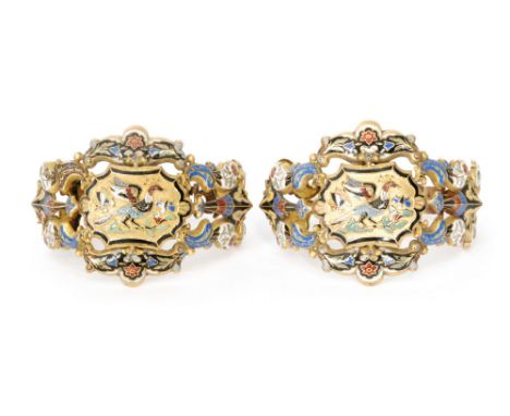 A pair of 19th Century French gilt metal and enamel bangles, each with scrolled floral panels  picked out in blue, black, red