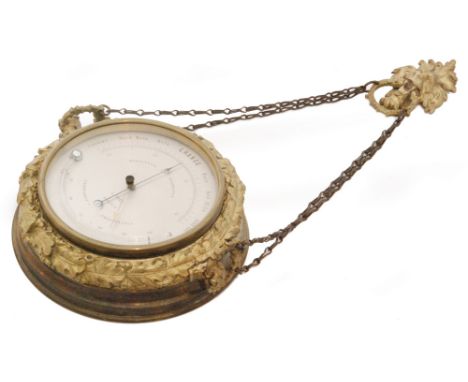 An early 20th Century brass mounted holosteric PHBN wall barometer, the circular silvered dial with arrow and crescent pointe