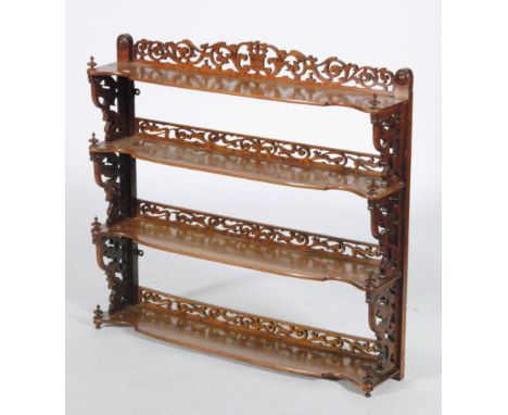 A Victorian walnut four tier what-not bracket shelf, with fret-cut galleries and side panels, height 86cm and width 92cm, S/D