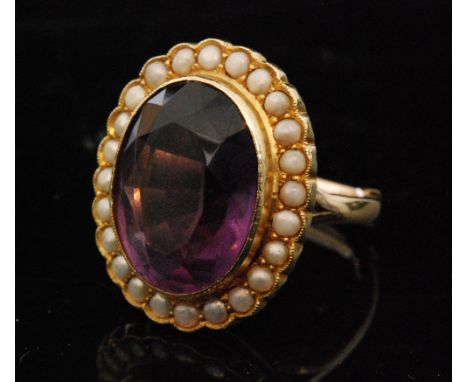 A Victorian 9ct amethyst and seed pearl ring, oval mixed cut amethyst collar set within a border of seed pearls, domed mount 