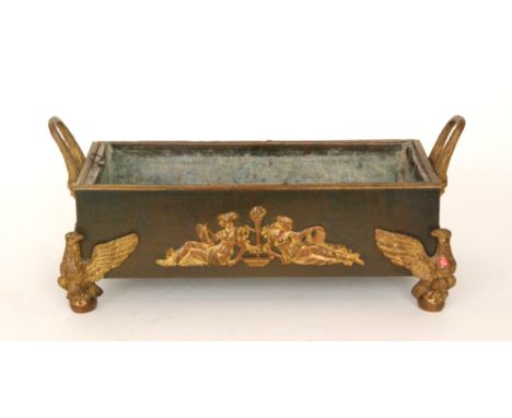 A French Empire period Palais Royal rectangular twin handled trough with applied gilt metal decoration and raised on phoenix 