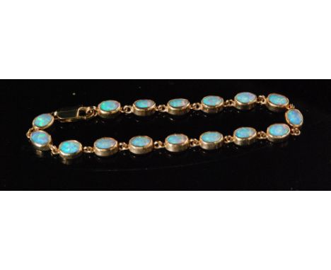 A modern 9ct hallmarked opal bracelet comprising of sixteen oval collar set stones terminating in lobster clasp, length 20cm.