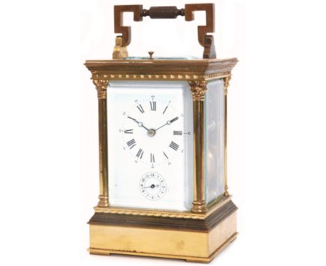 A late 19th Century French brass carriage clock in glazed pillared case with push button repeat, white enamelled dial and sec