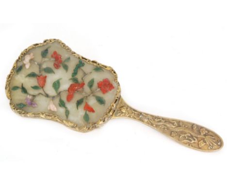 An early 20th Century Chinese hand mirror of cartouche form the back inset with a jade coloured panel and mounted with traili