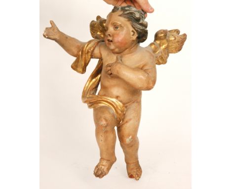 An Italian 17th to 18th Century carved pine and gesso putti, painted body with gilt wings, the outstretched arm draped with a