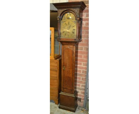 An 18th Century and later oak longcase clock with thirty hour movement, the 12 inch brass raised broken arch dial with subsid