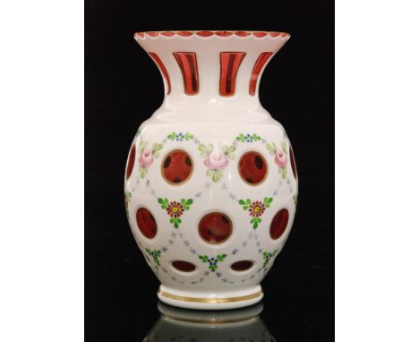 A mid 20th Century Crystalex of Bohemia glass vase of footed swollen form with flared neck, cased in opal over ruby, hand ena