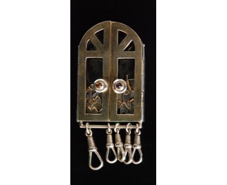 A continental silver and silver gilt key fob modelled as an arched window, the door knobs set with citrine and amethyst caboc