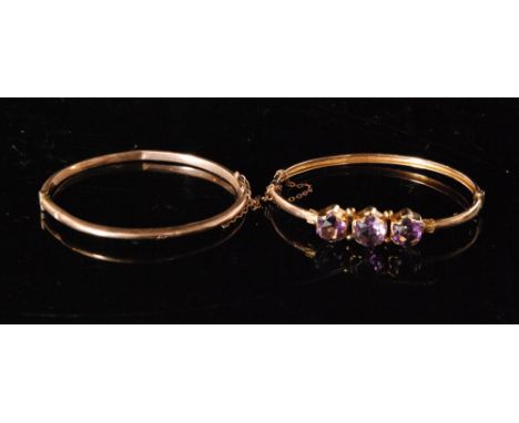 A Victorian rose gold and amethyst hinged bangle centrally set with three mixed cut collar set amethysts and another plain ex