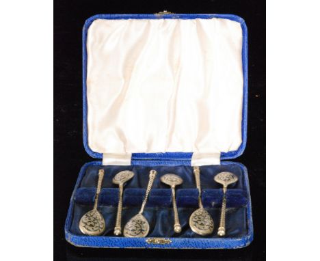 A cased set of six Russian silver tea spoons, twisted stems above shaped oval bowls with black enamel scroll decoration, S/D.