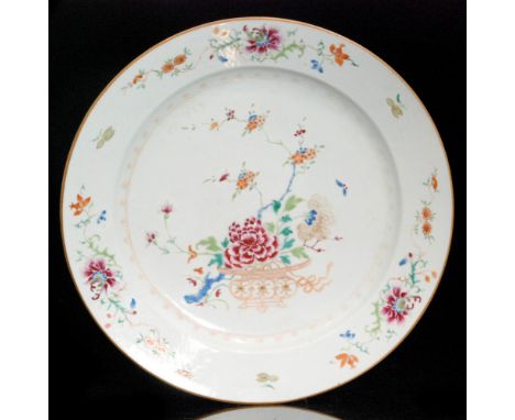A large 19th Century Chinese Famille Rose shallow charger enamel decorated with a basket of flowers and foliage against the o
