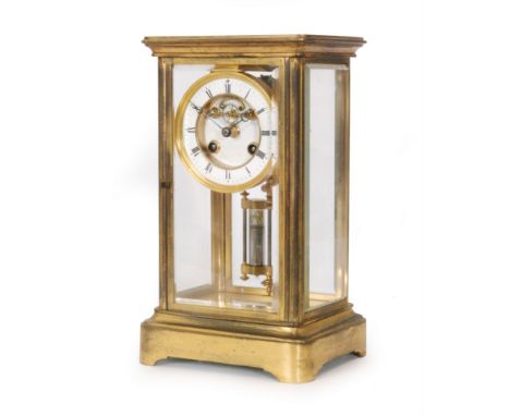 A 19th Century brass mantle clock with anchor escapement enclosed by bevelled glass sides and double filled mercury pendulum,