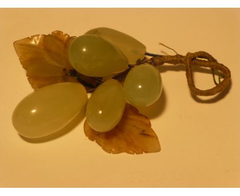 A small cluster of carved hardstone grapes and grape leaves (believed to be Jade) attached on a twisted wire stem, with strin