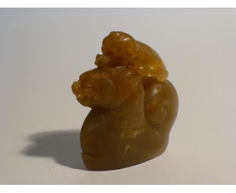 A Chinese jade figural carving modelled as an amphibian creature on a dragon's back, h. 9 cm