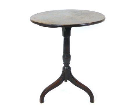 An early 19th century oak and beech tilt top tripod table, the two piece top over a turned column on splay legs, h. 70 cm, di