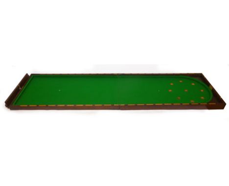 A mid 20th century mahogany folding bagatelle table with green baize interior, turned and numbered scoring depressions and bo