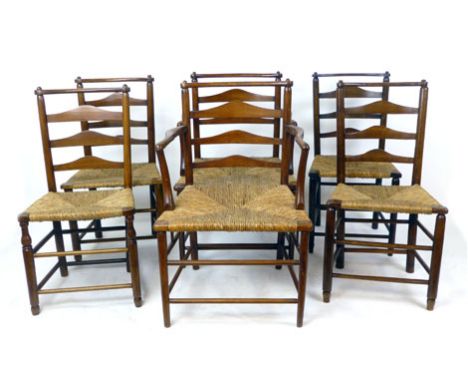 A harlequin set of six 19th century beech and elm ladderback chairs, including two carvers, with rush seats, the shaped top r