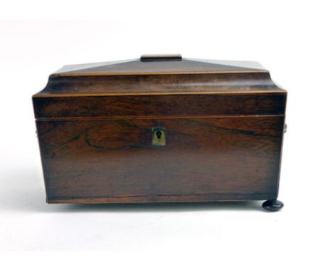 A Regency rosewood and boxwood strung tea caddy of sarcophagus form, with lion mask handles, on squat bun feet, h. 20 cm, w. 