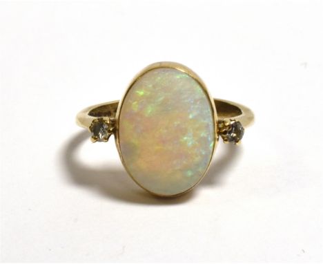 9CT OPAL AND DIAMOND DRESS RING with a bezel set oval cabochon cut, solid white opal, with a good play of colour, estimated t