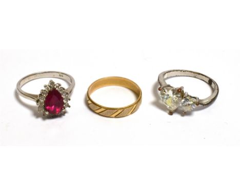 THREE DRESS RINGS to include a 3.8mm wide, 14ct gold band decorated with chevron style engraving, stamped 585.  Weight 2.0 gr