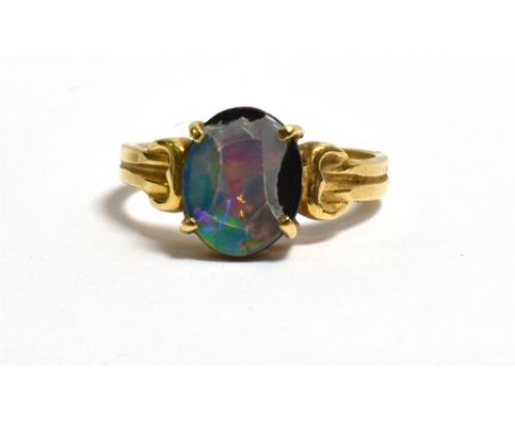 18CT GOLD OPAL TRIPLET DRESS RING with claw set oval opal triplet (badly chipped and cracked), ring size O 1/2, stamped 750. 