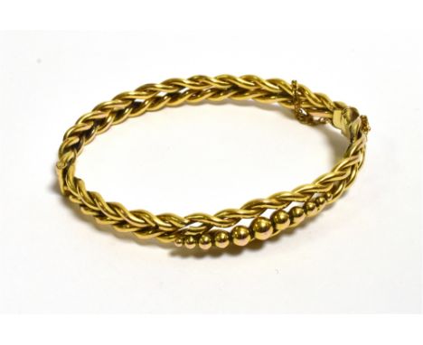 9CT GOLD PLAITED STYLE BANGLE 10.1-6.8mm graduated front decorated with orbs (several are missing) with hinge to one side and