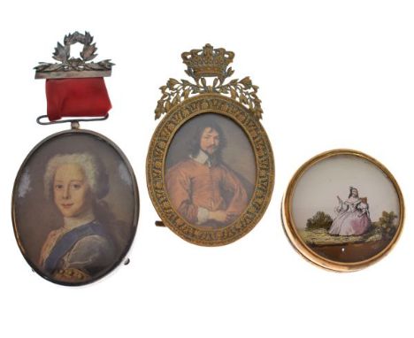 Two printed oval miniatures, one with ribbon pendant and laurel pin brooch, the other in crowned brass easel frame, together 