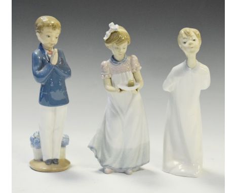 Two Lladro porcelain figures, and a Nao figure of a boy with hands clasped together, the tallest 20cm high  