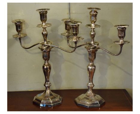 Pair of Art Deco-style silver-plated candelabra, each of two-branch (three-light) design on spreading octagonal bases, stampe