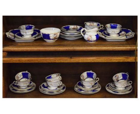 Continental porcelain tea service decorated with exotic birds against a blue ground, the base with transfer printed floral wr