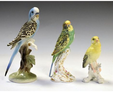 Royal Worcester budgerigar having puce backstamp, 17cm high, together with an Austrian figure of a blue budgerigar and one ot
