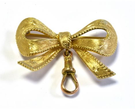 9CT GOLD BOW BROOCH 3.8cm wide, decorated with linen textured engraving, accentuated with daisy motifs, on a wire pin and rol