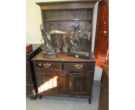 Small antique oak dresser with a boarded shelf back above two drawers and panelled doors (with alterations)