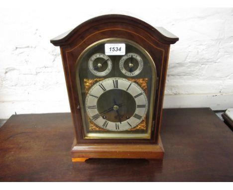 Edwardian mahogany and line inlaid bracket clock, the arched case enclosing a gilt brass dial with silvered chapter ring, Rom