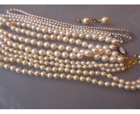 Single row graduated cultured pearl necklace with a diamond set clasp together with a quantity of simulated pearl necklaces