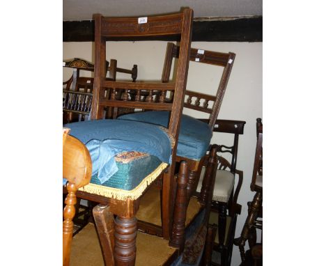 Set of ten late Victorian walnut dining chairs with carved and spindle rail backs above carpet covered stuffover seats and tu