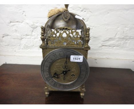 Reproduction gilt and silvered lantern clock, the silvered dial with Roman numerals, the two train movement striking on a bel